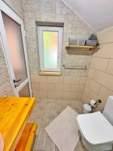 a bathroom with a toilet and a window at N'Baz Apartment Lezhë in Lezhë +34 photos