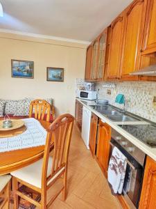 a kitchen with a table and a dining room at N'Baz Apartment Lezhë in Lezhë