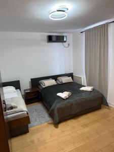 a bedroom with a bed with two towels on it at Motel Victoria in Zvornik