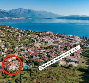 a house with a sign in front of a city at Monte Aria panorama suites in Herceg-Novi +84 photos