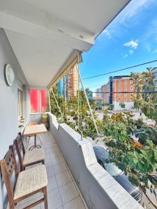 a balcony with chairs and a view of a city at N'Baz Apartment Lezhë in Lezhë