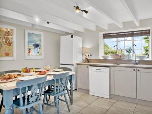 a kitchen with a table and chairs and a counter at Bobs Cottage Porlock Weir in Porlock