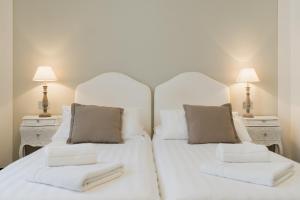 a bedroom with two white beds and two lamps at Villa Telli in Garda +31 photos