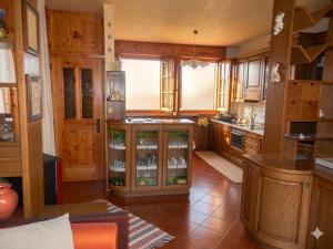 a large kitchen with wooden cabinets and a counter at Casa Elda in Valdidentro