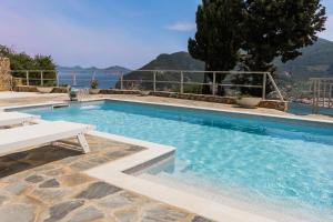 a swimming pool with a view of the water at Villa Mirage Skopelos in Skopelos Town