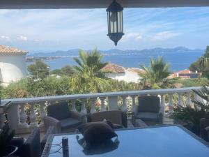 a balcony with a view of the water at Villa Kahina in Les Issambres
