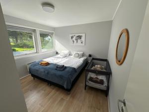 a small bedroom with a bed and a window at Just a Simple House in Senjahopen