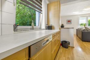 a kitchen with a counter top and a window at Ferienwohnung Halde Hoheward in Recklinghausen