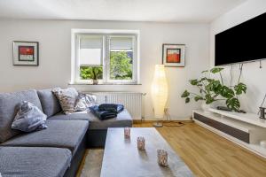 a living room with a couch and a tv at Ferienwohnung Halde Hoheward in Recklinghausen