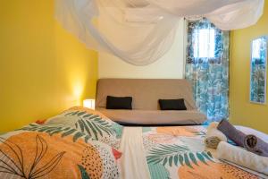 a bedroom with two beds and a window at Gites villa bagatelle piscine et Plage à 900m in Sainte-Rose +92 photos