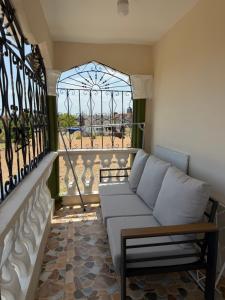 a living room with a couch and a window at Elysium Noire in Spanish Town