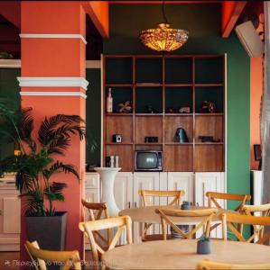 a dining room with orange and green walls at CONTE CRISTO Suites in Paralia Katerinis