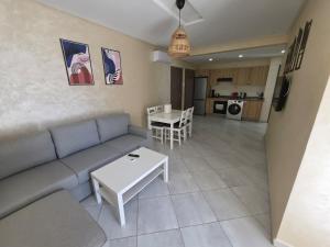a living room with a couch and a table at Marina smir Oceanica Apartments in Marina Smir