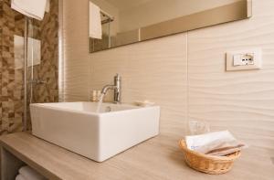 a bathroom with a white sink and a mirror at Il Rifugio Dei Templari in Lecce