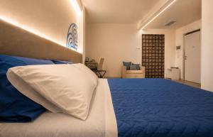 a bedroom with a bed with a white pillow at Il Rifugio Dei Templari in Lecce +20 photos