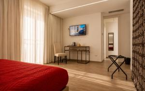 a bedroom with a bed and a desk and a television at Il Rifugio Dei Templari in Lecce