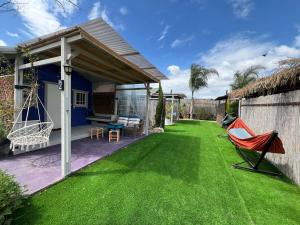 a lawn with a hammock and a house at פרא בקתות אירוח - מתחם נופש כפרי עם בריכה פרטית in Nir Yafe +28 photos