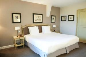 a bedroom with a large bed with white sheets and pillows at Château Sainte Sabine in Sainte-Sabine +48 photos