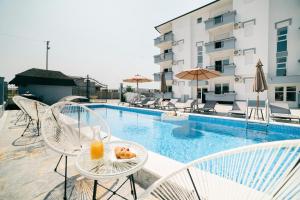 a meal on a table next to a swimming pool at Lux Ariana in Donji Štoj
