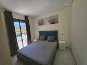 a bedroom with a bed and a large window at Marina smir Oceanica Apartments in Marina Smir +192 photos