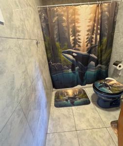a bathroom with a shower with a toilet and a shower curtain at Alojamientos Adele II in San Miguel