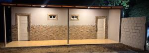 a room with two doors and a brick wall at Alojamientos Adele II in San Miguel