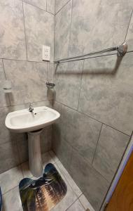 a bathroom with a white sink and a shower at Alojamientos Adele II in San Miguel