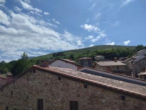 a view of a town with a hill in the background at Posada San Miguel in RIonansa +5 photos