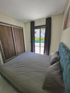 a large bed in a room with a window at Marina smir Oceanica Apartments in Marina Smir