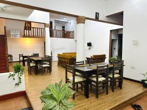 a restaurant with tables and chairs in a room at New Rani Inn in Negombo