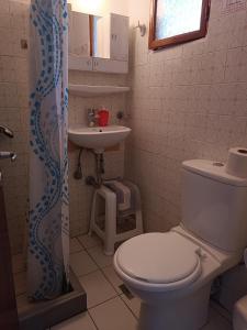 a bathroom with a toilet and a sink at Haras rooms in Nikiana