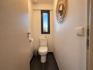 a bathroom with a toilet and a window at Sea Road Perpignan in Perpignan +20 photos