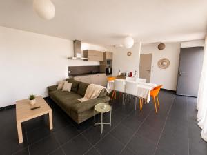 a living room with a couch and a table at Sea Road Perpignan in Perpignan