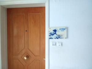 a door in a room with a poster on the wall at Kyma studio Modern Stay in Nea Artaki