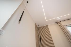 a clock hanging from the ceiling of a room at VJ Apartment in Giardini Naxos +67 photos