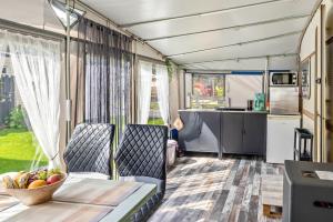 an rv kitchen with a table with a bowl of fruit at La Pura Vida - Glamping in Brandenburg an der Havel