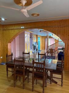 a dining room with a large table and chairs at Giggle in Srinagar
