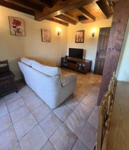 a living room with a couch and a tv at Gestiona2R - Casa en Colombres centro in Colombres