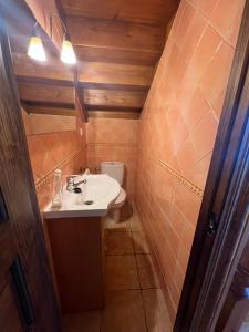a small bathroom with a sink and a toilet at Gestiona2R - Casa en Colombres centro in Colombres +36 photos