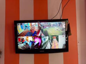 a flat screen tv hanging on a wall at Giggle in Srinagar