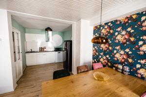 a kitchen and dining room with a table and a wall at bijDorien in Gennep
