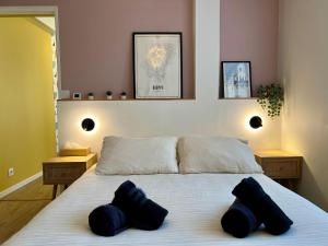 a bedroom with a bed with two pillows on it at La Cabine ménage et linge inclus in Dieppe