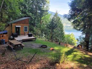 a cabin in the woods with a view of a lake at Moss Haven on Hood Canal in Quilcene