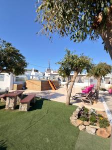 a park with a picnic table and trees and grass at Mykonos Secret Spot in Mikonos