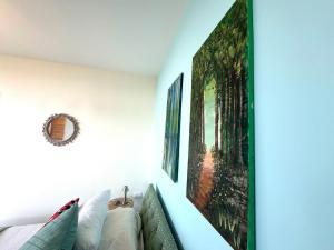 a room with a couch and two pictures on the wall at Shakti, Abdelli guesthouse in Batroûn