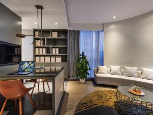a living room with a couch and a table at Mercure Nanjing Olympic EXPO in Nanjing