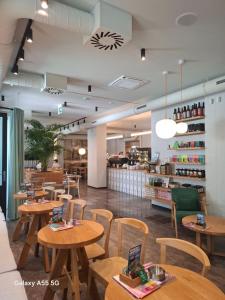 a restaurant with wooden tables and chairs and a counter at Stari Grad in Kragujevac +31 photos