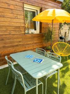 a blue table and chairs with an umbrella at Ker Sonia in Angers