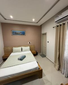 a bedroom with a large bed in a room at Havenstay in Yaoundé
