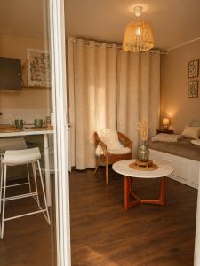 a living room with a table and a bed at Ker Sonia in Angers